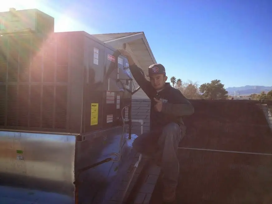 HVAC technician performing HVAC Inspection on a rooftop unit in North Coventry